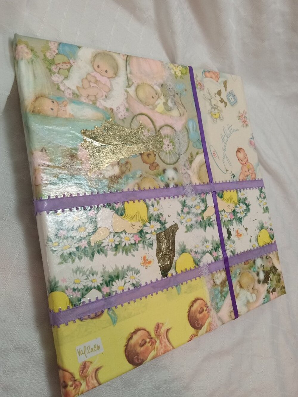 A handmade collage on canvas made from thin vintage wrapping paper